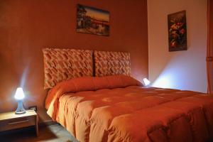 Un dormitorio con una cama con dos luces. en A due passi dal mare, en Capo dʼOrlando