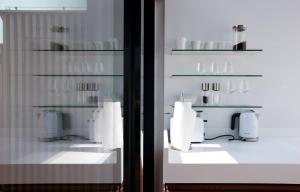 a room with a window with white dishes on shelves at Vienna Residence, City Hall - Parliament in Vienna +291 photos