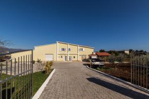 a building with a fence next to a driveway at Orange Tree Garden in Trogir