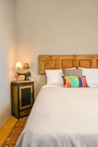 a bedroom with a large bed and a television at Urban Blue Guest House in Olbia