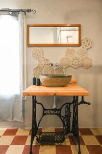 a counter with a sink and a mirror on a wall at Urban Blue Guest House in Olbia