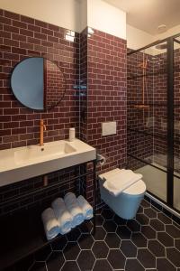 a bathroom with a sink and a toilet and a shower at FD Hotels in Rotterdam