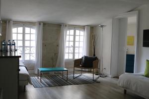 a living room with a couch and a table at In Situ B&B in Uzès