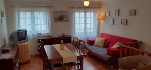 a living room with a couch and a table at Holiday House Tocha in Palheiros da Tocha