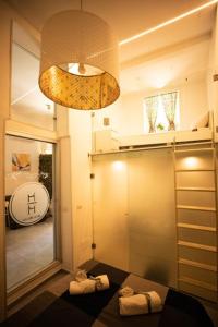 a bathroom with two folded towels and a mirror at Hrdo House in Syracuse