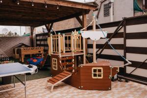 a childrens playground with a swing and a table at Villa "White Pearl" Zatoka in Zatoka