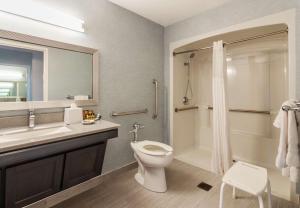 a bathroom with a toilet, sink and bathtub at Robert Treat Hotel, Premier Collection in Newark