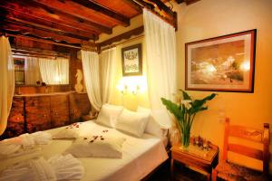 a bedroom with a large white bed in a room at Palazzo di Pietro in Chania