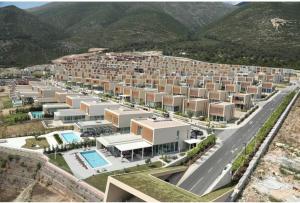 an aerial view of a resort with mountains in the background at Villa Amal Palase in Palasë