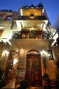 a building with a wooden door and a balcony at Palazzo di Pietro in Chania Town