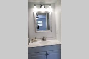 盖恩斯维尔Discover Luxury Condo Steps Away from Celebration Pointe and I-75!的带水槽和镜子的浴室 更多37张照片