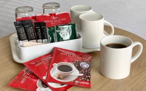 a tray with a cup of coffee and a mug of coffee at Premier Hotel Cabin Shinjuku in Tokyo