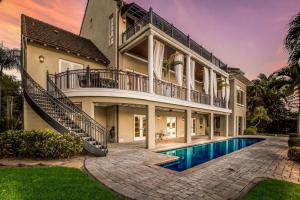 a large house with a swimming pool in front of it at Sarasota Luxury Estate in Sarasota