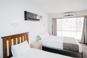 a bedroom with two beds and a window at Hurley's Bar & Bistro in Kyabram