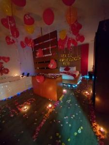 a living room with balloons and a room with a bed at Hotel AW Boutique in Bogotá