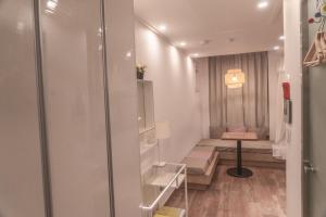 a small room with a bench and a table at Myeongdong Artmonstay in Seoul +259 photos