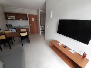 a living room with a flat screen tv on a wall at Salinas Exclusive Resort in Salinópolis