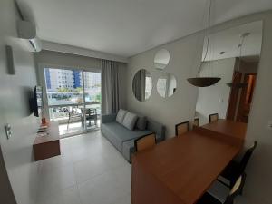 a living room with a couch and a dining room table at Salinas Exclusive Resort in Salinópolis