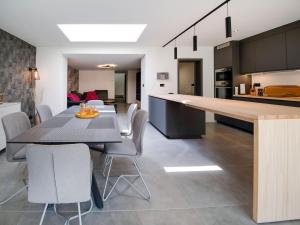 a kitchen and dining room with a table and chairs at Modern holiday home in Marchin with a jacuzzi in Marchin