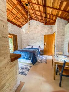 um quarto com uma cama e um tecto de madeira em Refúgio Physis Suítes em Monte Verde