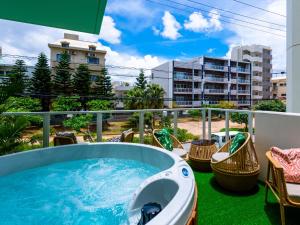 a hot tub on the balcony of a building at The Moana by DSH Resorts in Chatan