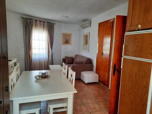 cocina y sala de estar con mesa y sofá en Zahara Pueblo, en Zahara de los Atunes