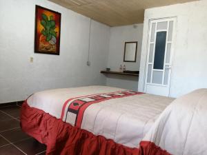 Giường trong phòng chung tại Axolokalko Teotihuacan