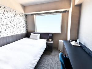 מיטה או מיטות בחדר ב-Wakoshi Tobu Hotel