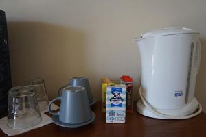 a counter with a blender and a box of milk at Palace Hotel Mortlake Sydney in Sydney +21 photos