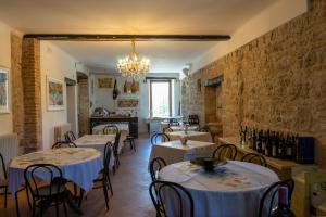 a restaurant with tables and chairs and a chandelier at Dimora BOUQUET & GOURMET in Ascoli Piceno