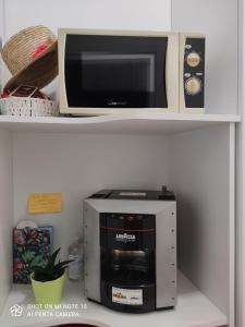 a microwave oven sitting on top of a shelf at RESIDENZA BURMARIA Free Parking in Tropea