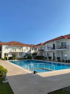 a swimming pool in front of some apartment buildings at Квартира рядом с морем in Kemer