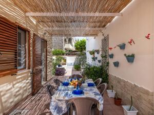a patio with a table and chairs on a patio at Poetto seaside in Cagliari