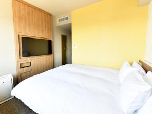 מיטה או מיטות בחדר ב-Wakoshi Tobu Hotel