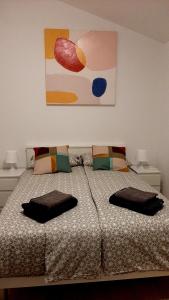 a bedroom with a bed with two pillows on it at Holiday House Romi in Pula