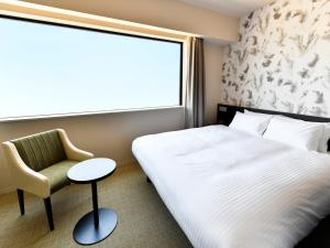 מיטה או מיטות בחדר ב-Wakoshi Tobu Hotel