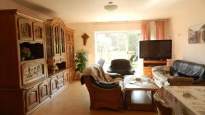 a living room with couches and a tv at Petriheil in Nohfelden