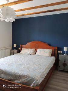 a bedroom with a bed with a blue wall at Apartamento Elizaldea in Betelu +22 photos