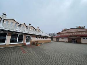 an empty parking lot in front of two buildings at Penzion Na Císařství in Horní Suchá