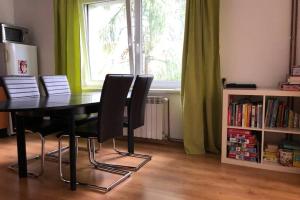 a table and chairs in a room with a window at Dom, Apartamenty, Agroturystyka in Kacwin