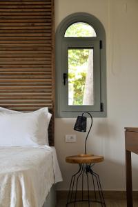 a bedroom with a bed and a window at PargaMondo Countryliving in Parga