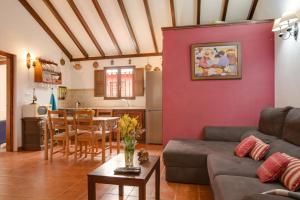 a living room with a couch and a table at La Finca de Teror in Teror