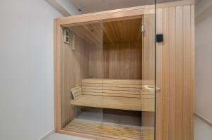 a sauna with a glass door in a room at Luxury Villa Ane in Malinska
