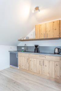 a kitchen with wooden cabinets and a blue counter top at Pension Talblick in Sulz am Neckar