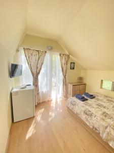 a bedroom with a bed and a large window at Sirena Holiday Park in Kamchia +148 photos