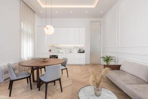 a living room with a table and a couch at Plaza Apartments in Opatija