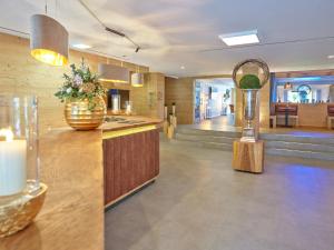 a kitchen with a trophy on a counter and a lobby at Parkhotel Bad Griesbach in Bad Griesbach +111 photos