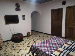 a bedroom with a bed and a flat screen tv at The Village Apartments, Gbagada in Lagos +15 photos