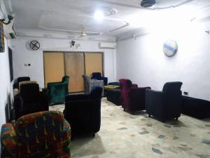 a room with a bunch of chairs in it at Room in House - The Village Apartments, Gbagada O9o98o58ooo in Lagos