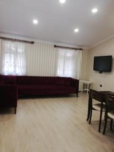 a living room with a couch and a flat screen tv at şerah bungawilla in Uzungöl